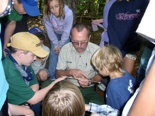 State Forester showing students boring of pine tree.