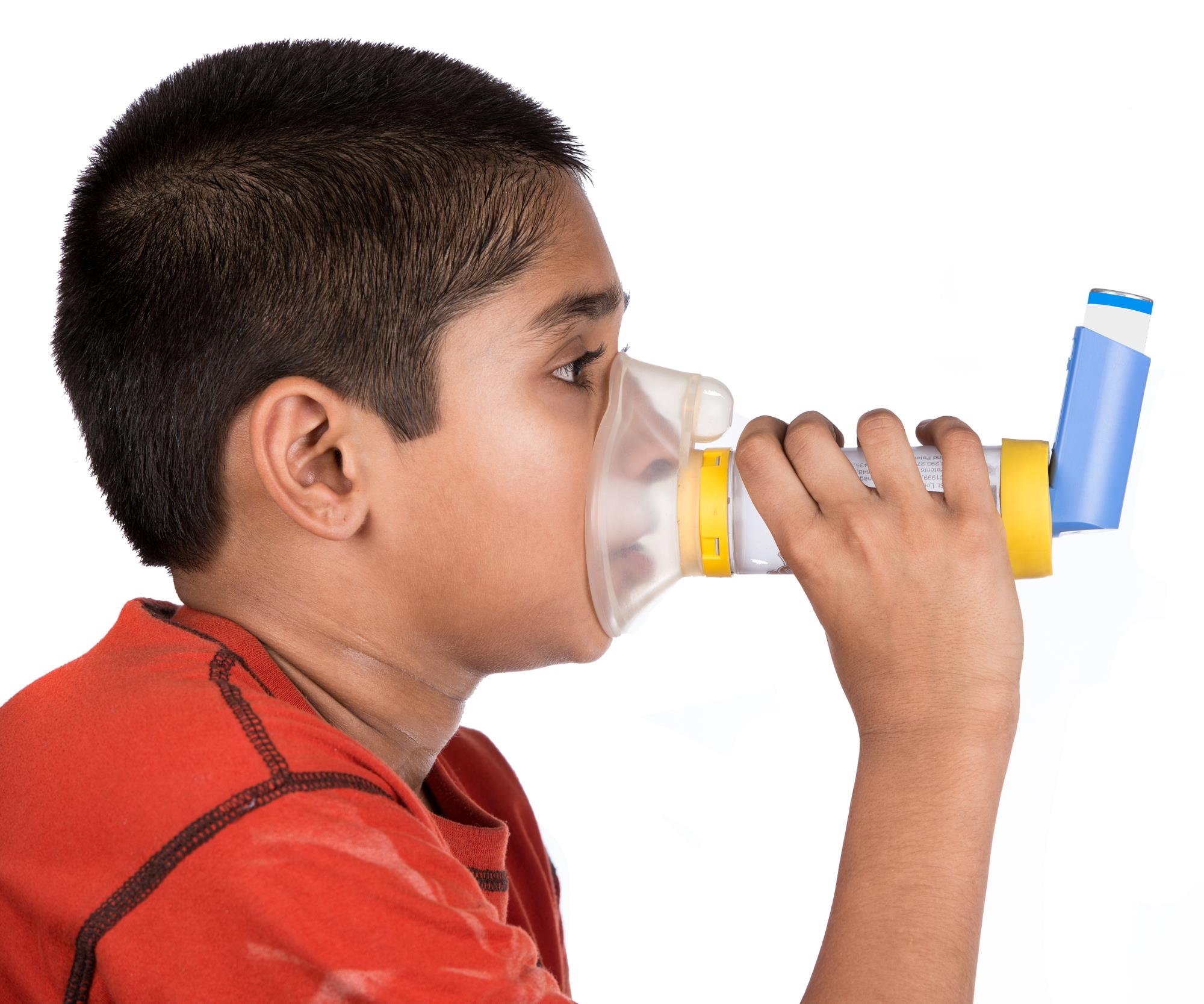 A young boy using an inhaler