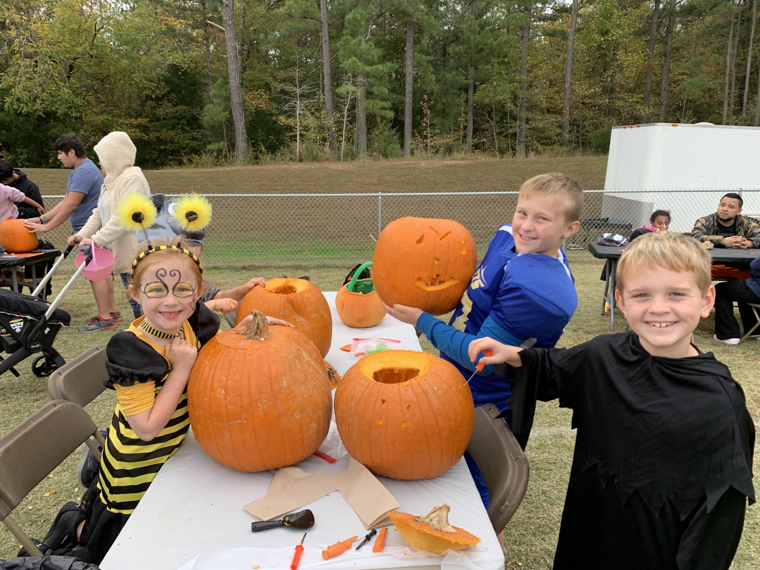 Trunk or Treat Fall Festival - kids carving pumpkins