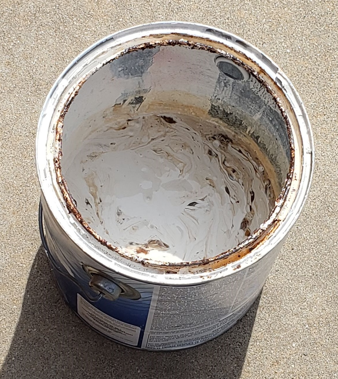 1 gallon paint can with a couple of inches of liquid latex paint