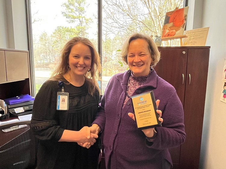 An image of Ashlyn Martin and Genevieve Megginson with her 6 over 60 award.