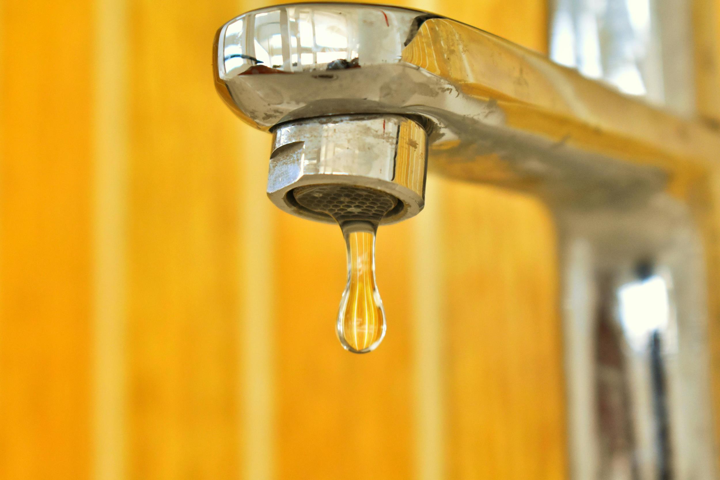 Water dripping from an indoor faucet